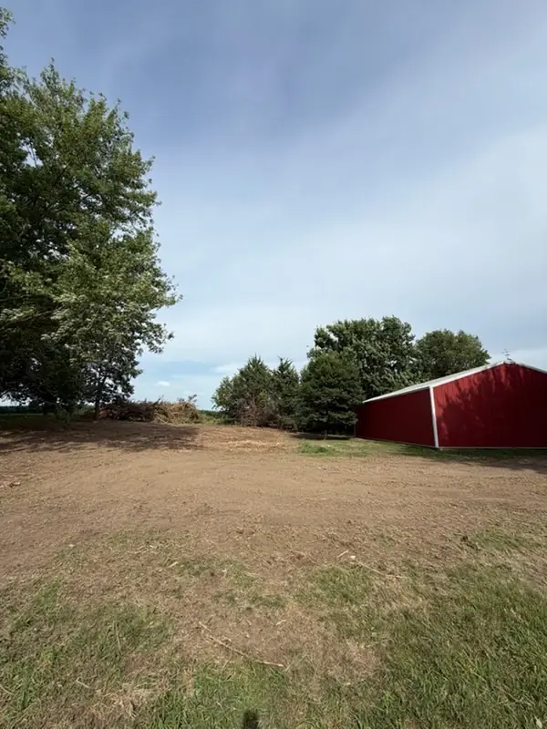Prepared ground beside a red outbuilding
